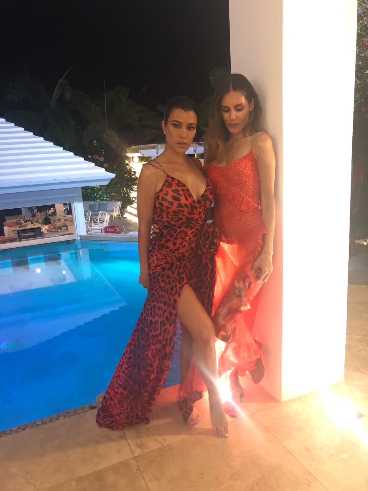 Kourtney Kardashian and friend wearing red dresses