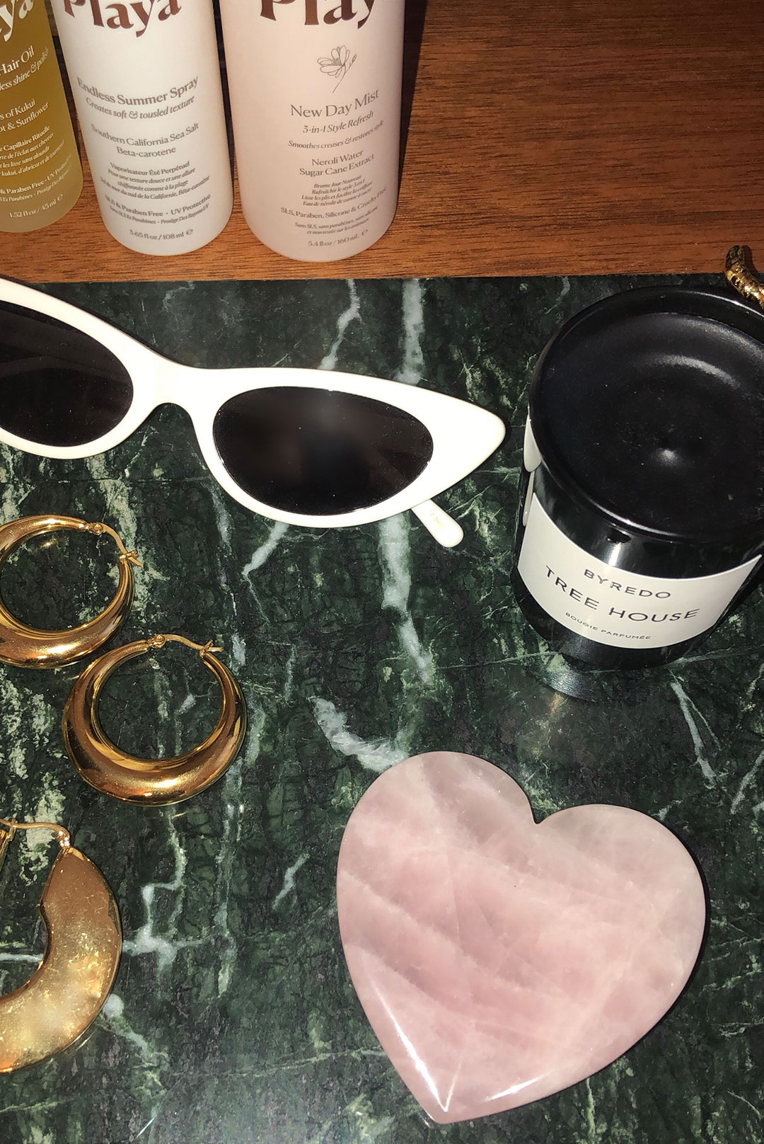 Aesthetic photo with rose quartz and sunglasses