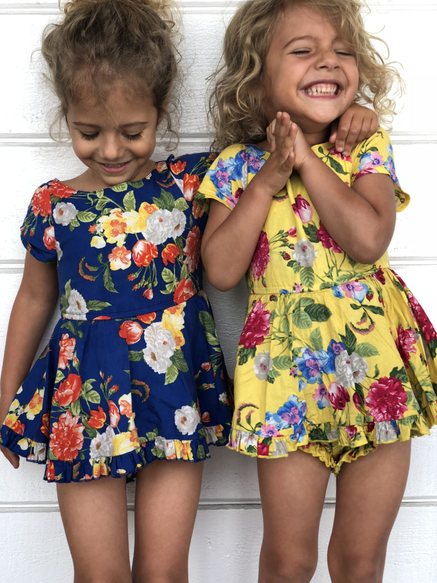 children smiling in floral dresses
