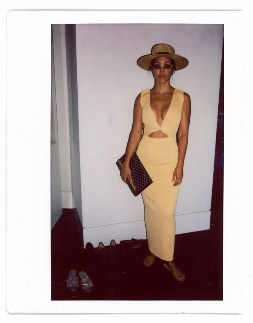 Kourtney Kardashian wearing yellow dress and sun hat