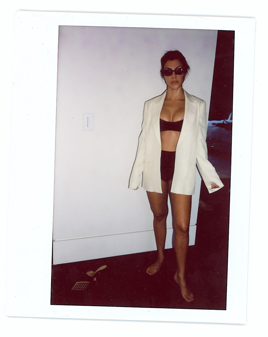 Kourtney Kardashian wearing swimsuit top and blazer