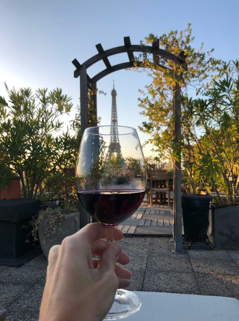 glass of wine near eiffel tower