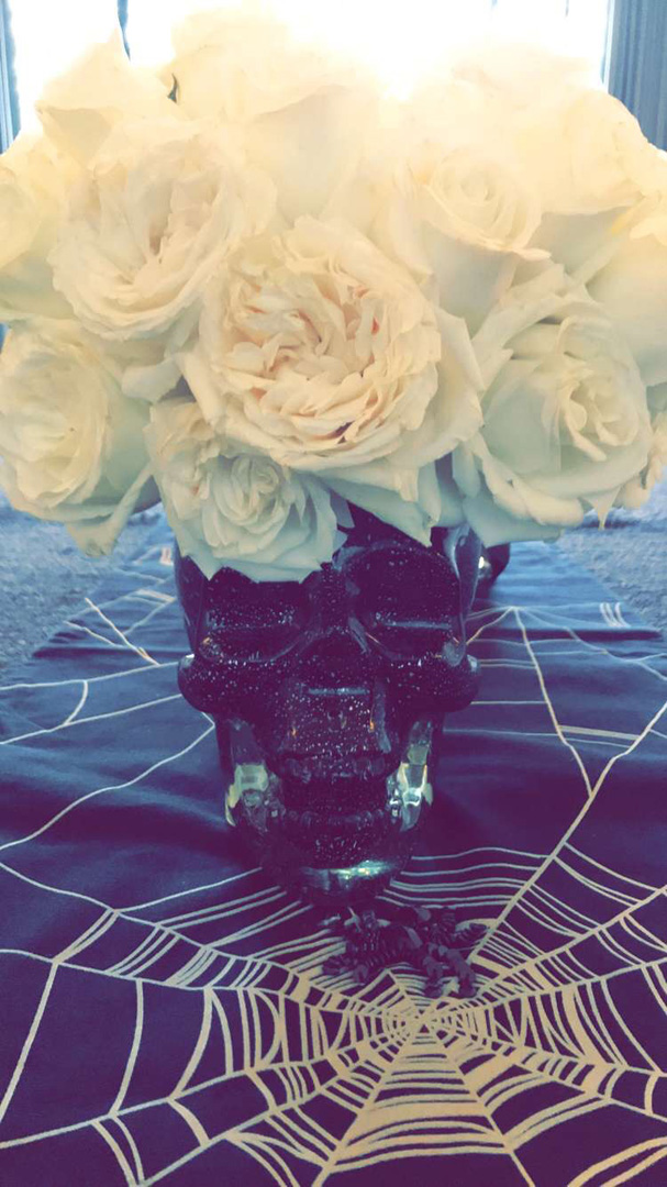 Kourtney Kardashian Halloween table spider web and white roses