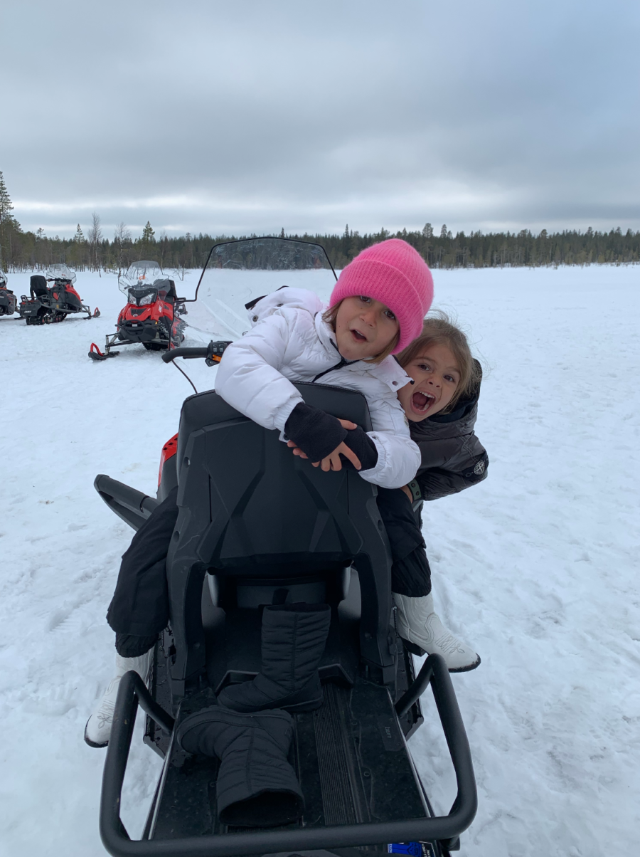 Penelope and Reign Disick on snowmobile in Finland