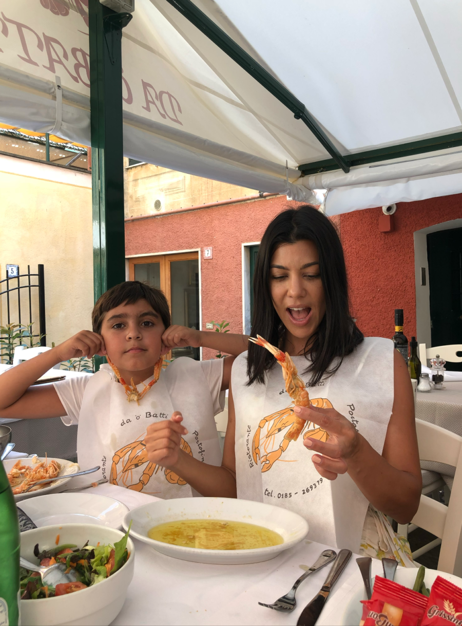 kourtney kardashian and mason eating shrimps in italy