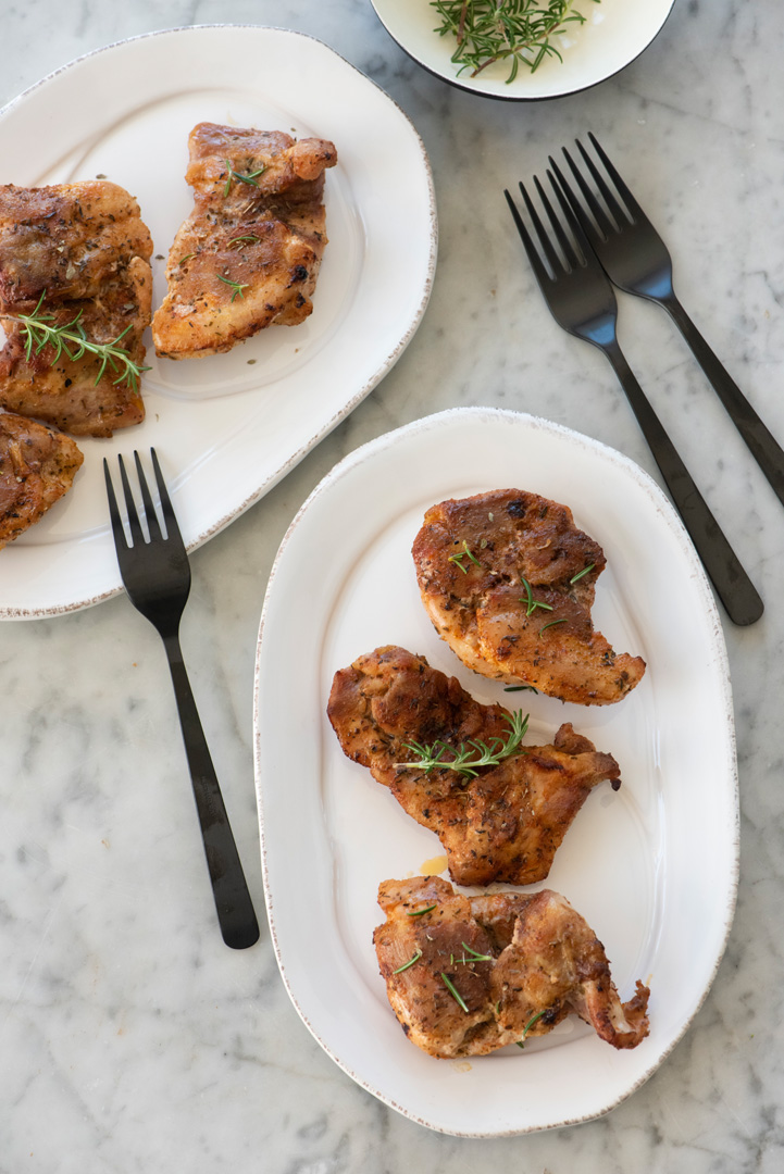 Gluten-Free Butter-Baked Chicken Thighs on a plate with forks