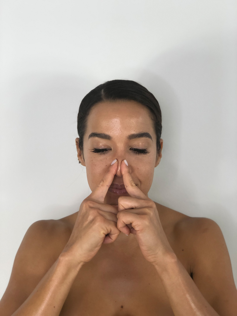 woman showing how to give a facial massage Step6