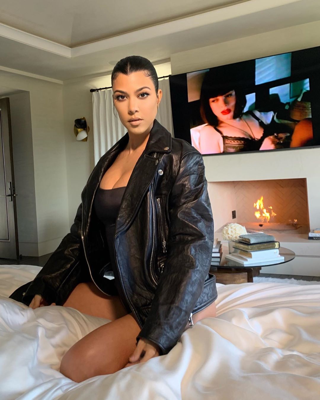 kourtney kardashian wearing skims bodysuit and leather jacket