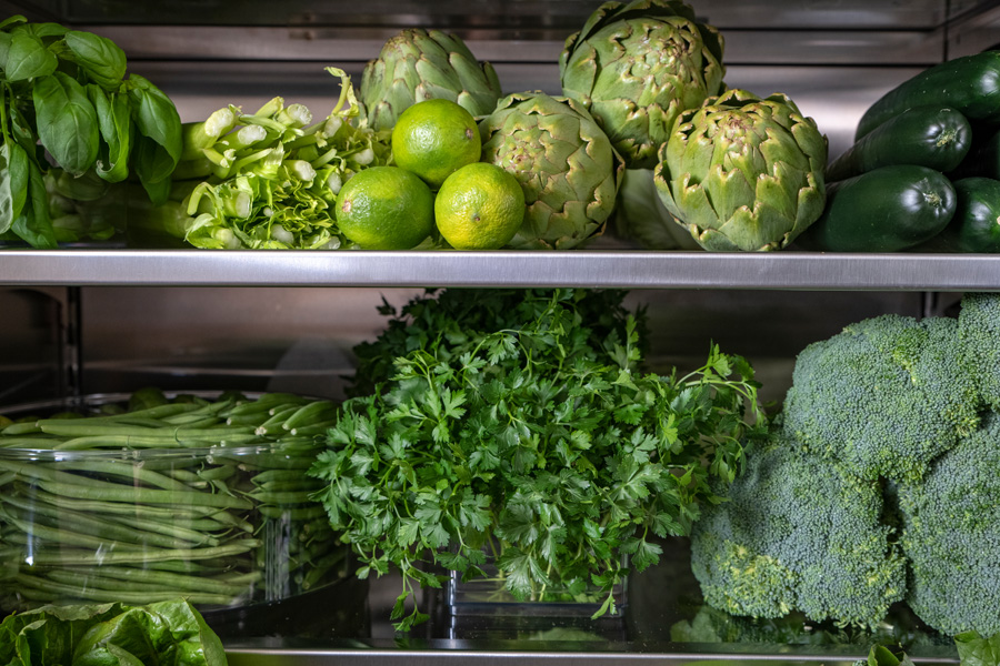 Kris Jenner refrigerator close up of cilantro and broccoli