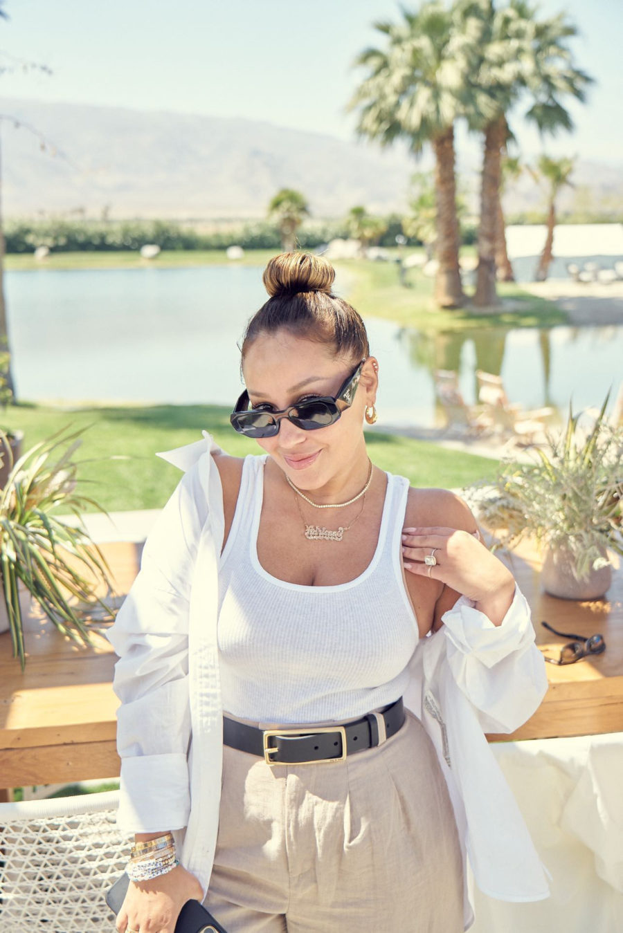 Adrienne Bailon in white tank and pant at camp poosh