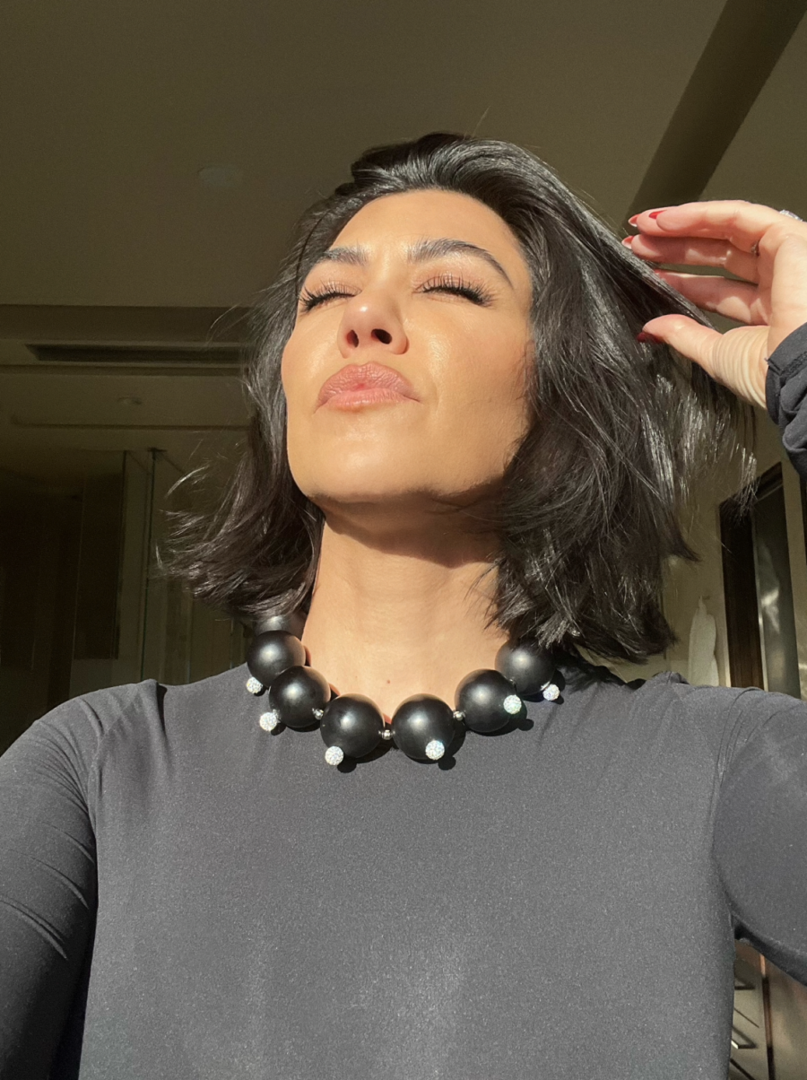 Kourtney Kardashian selfie eyes closed in sunlight