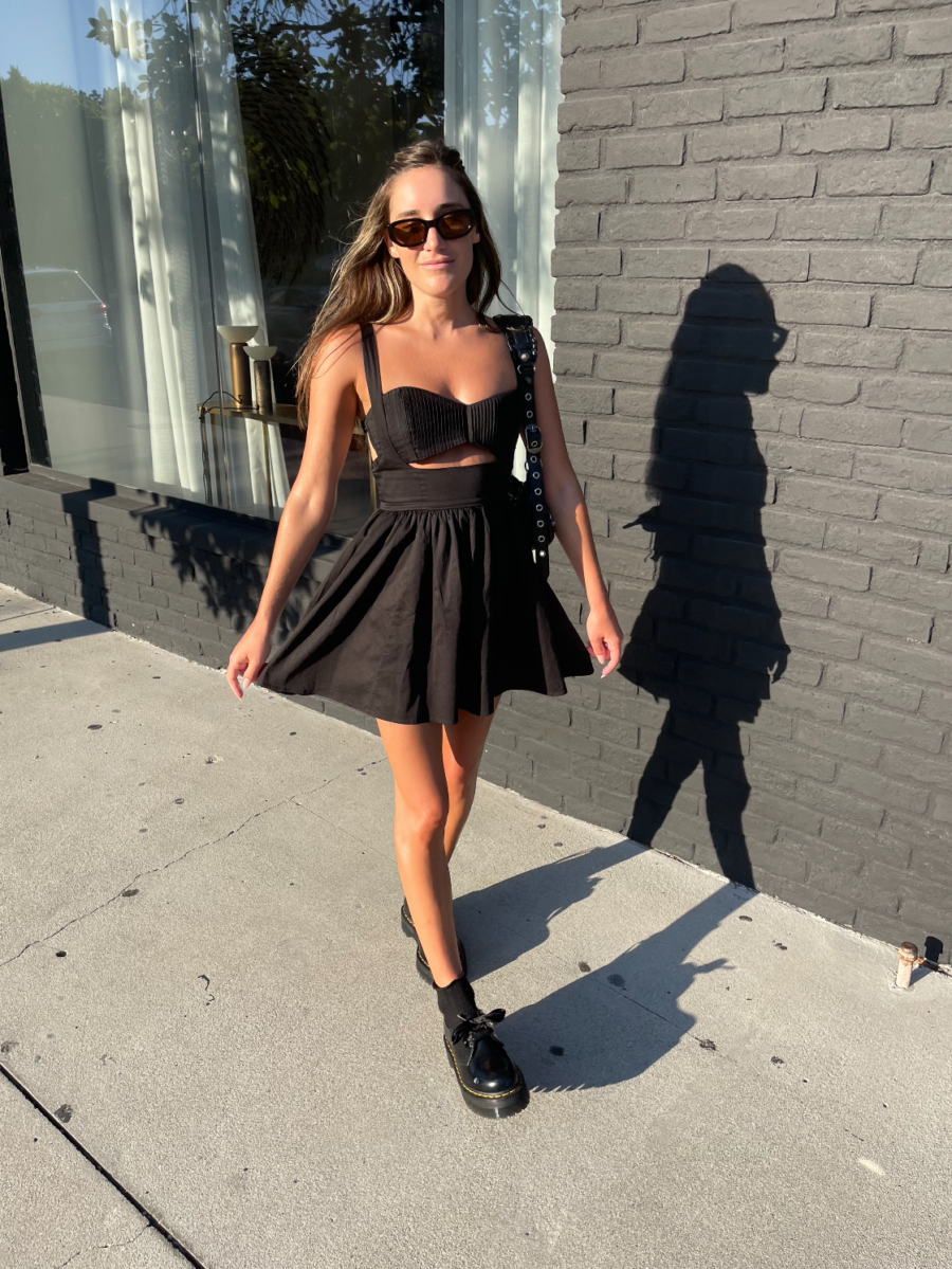 woman wearing black dress and doc martens