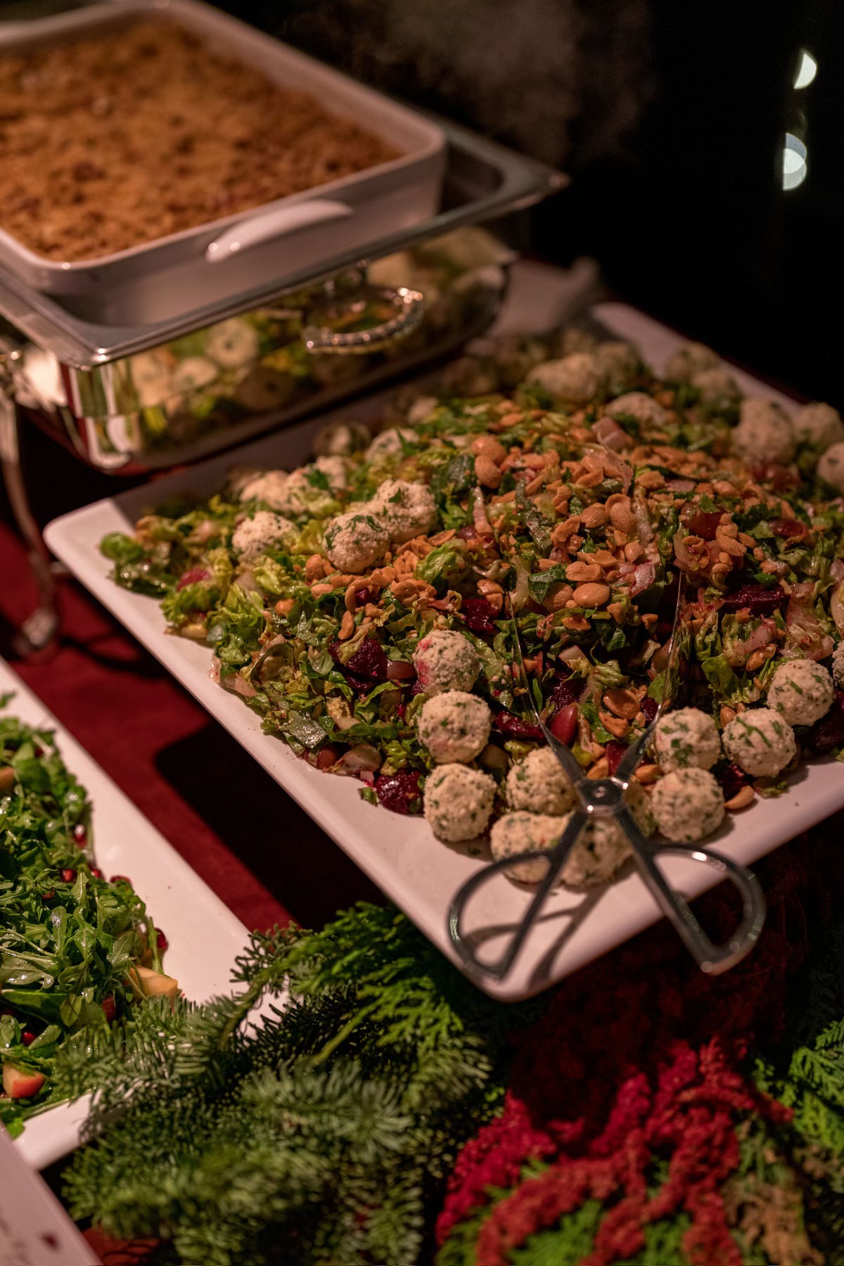 Vegan food spread on large white ceramic trays at Dipped candy at Kourtney Kardashian Barker Christmas Eve 2022 party