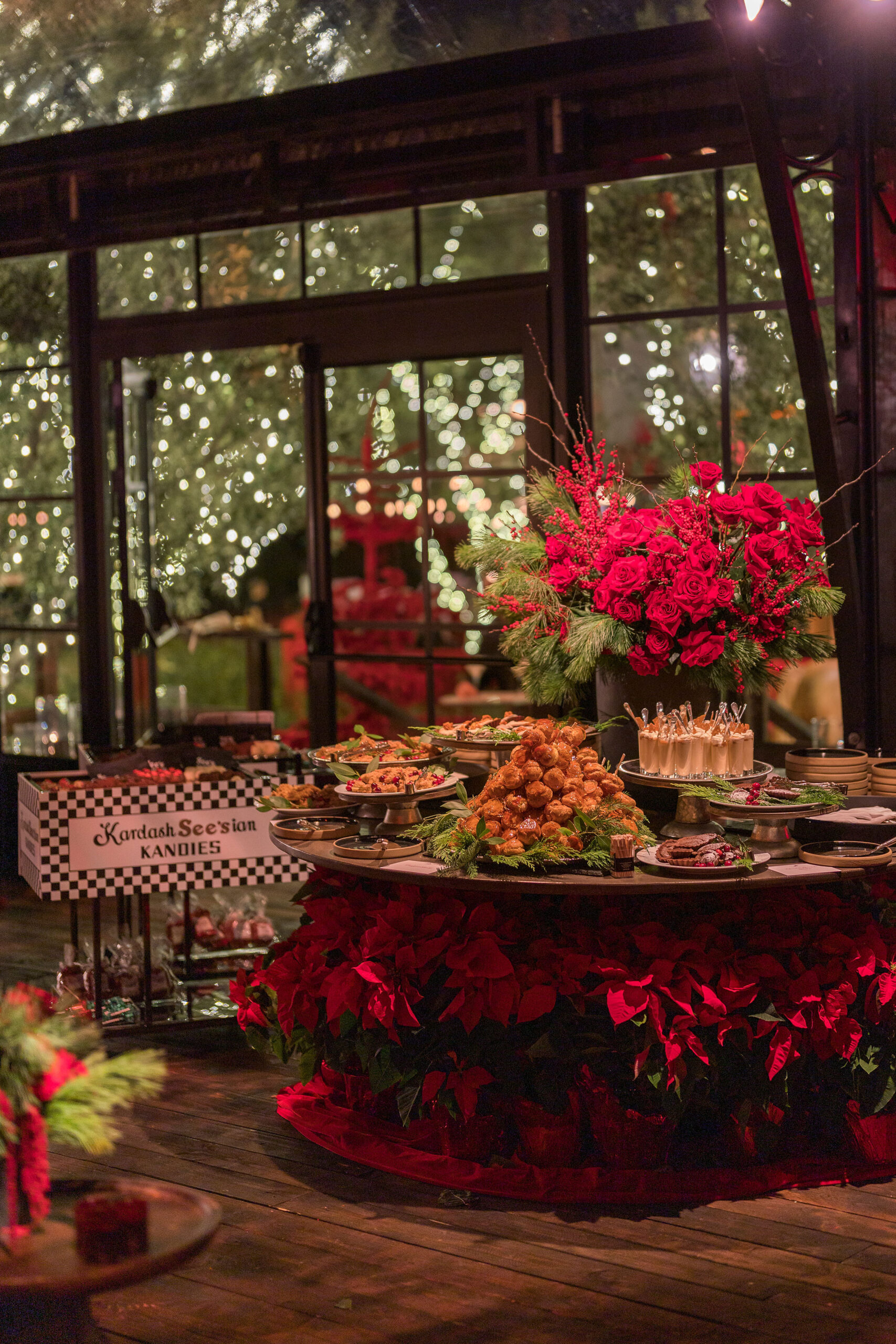 Food spread in front of See&#8217;s candies cart at Kourtney Kardashian Barker Christmas Eve 2022 party