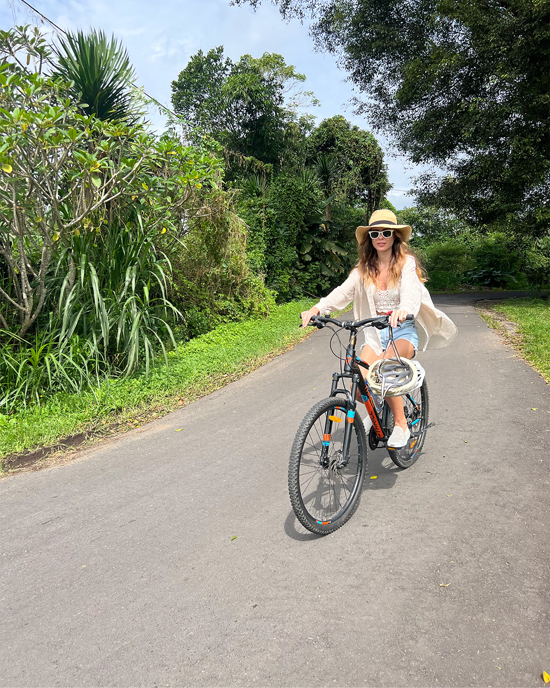 Woman riding bike through Bali