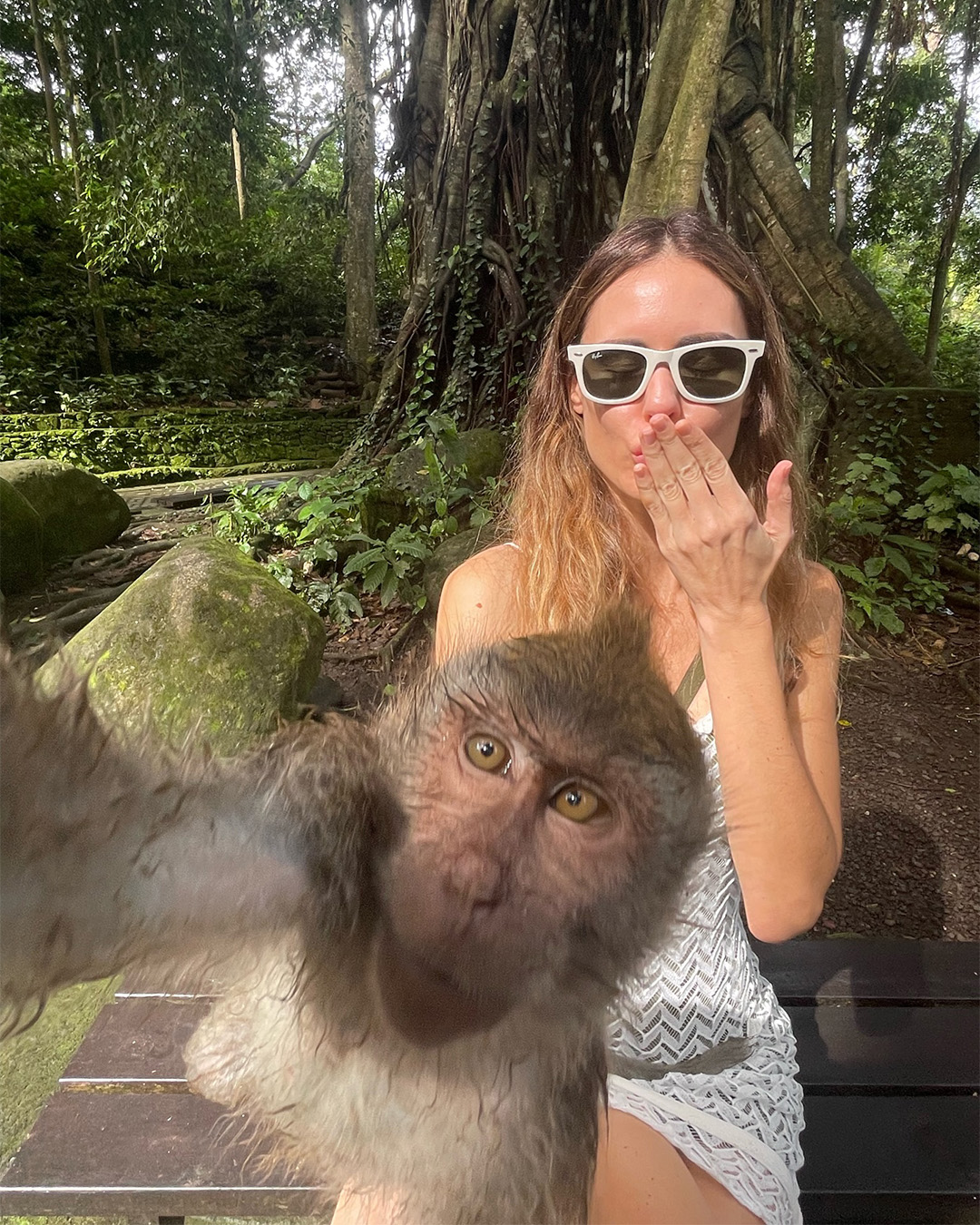 Women posing with monkey in Bali