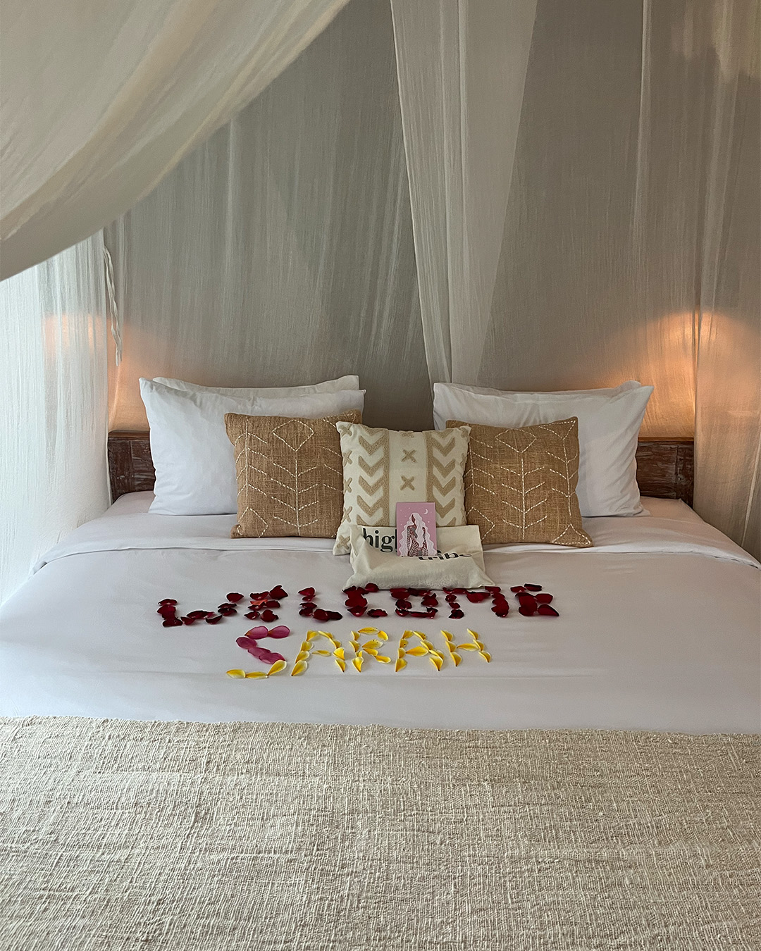 White bed with Canopy and Floral Spelling Out &#8220;Welcome Sarah&#8221;