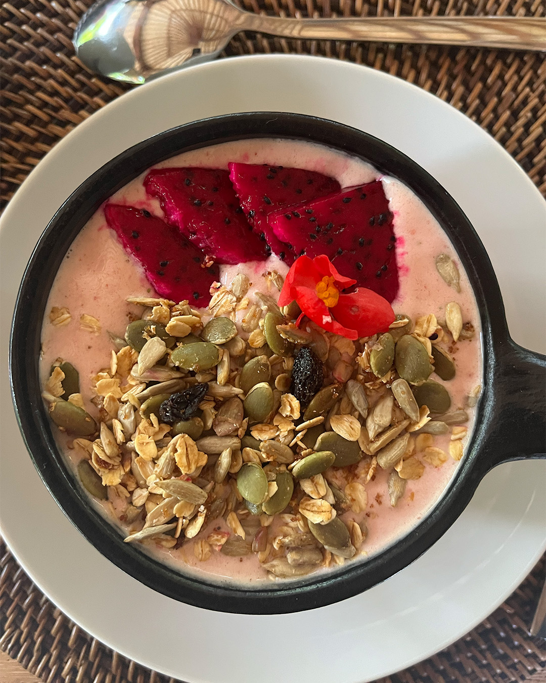 Pink Smoothie bowl with dragonfruit, granola and pumpkin seeds