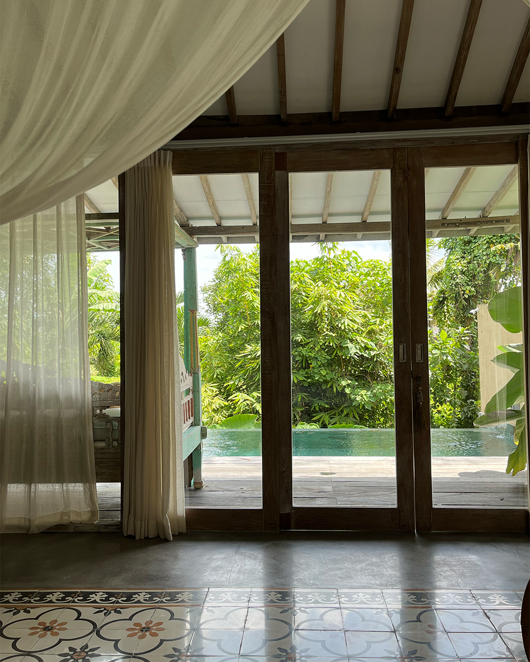 Bedroom view with glass doors with pool