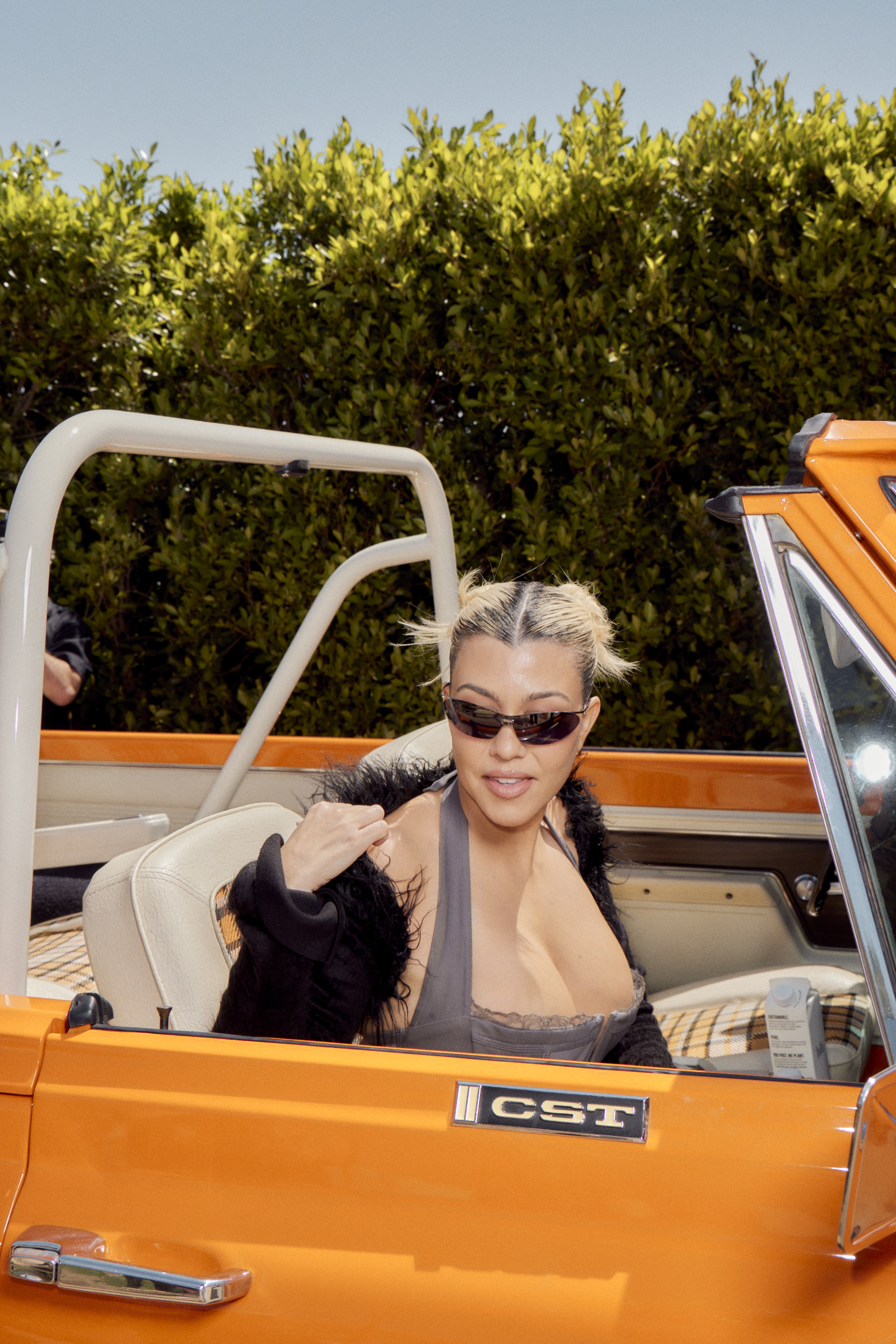 Kourtney Kardashian Barker in Orange Car