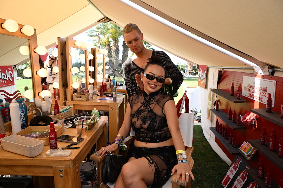 A woman getting her hair done inside the Wella tent.